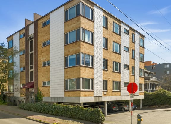 an apartment building on a street corner with a stop sign