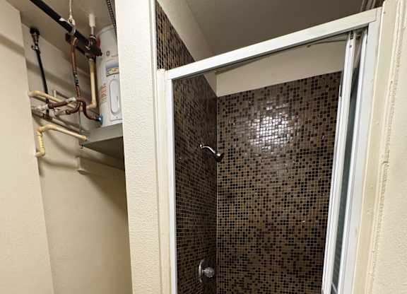 A bathroom with a toilet, sink and shower.