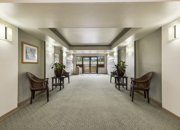 a large hallway with chairs and tables and a doorway