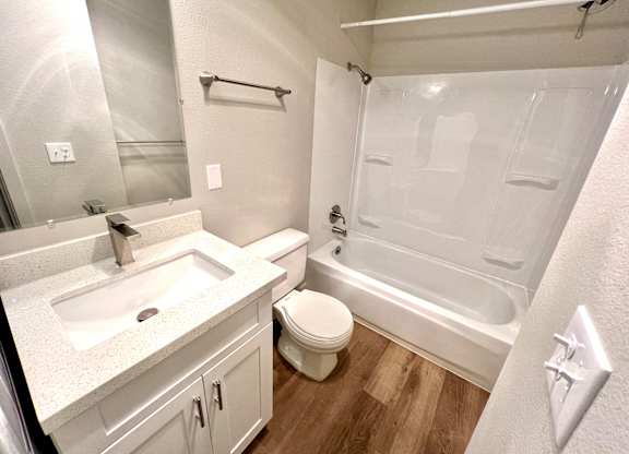 2-bedroom bathroom with a white & black washing machine and dryer and a shower & tub combination at Bridgeport Terrace Apartments