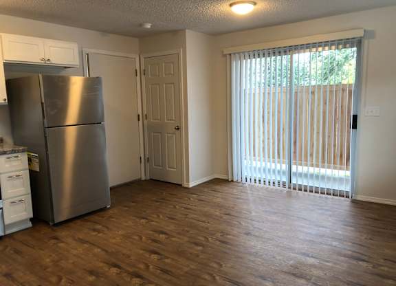Studio kitchen and living space with storage closets and sliding glass door at  Bridgeport Terrace apartments