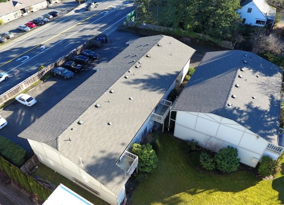Aerial view of Bridgeport Terrace Apartments with black roof and white and tan painted siding.