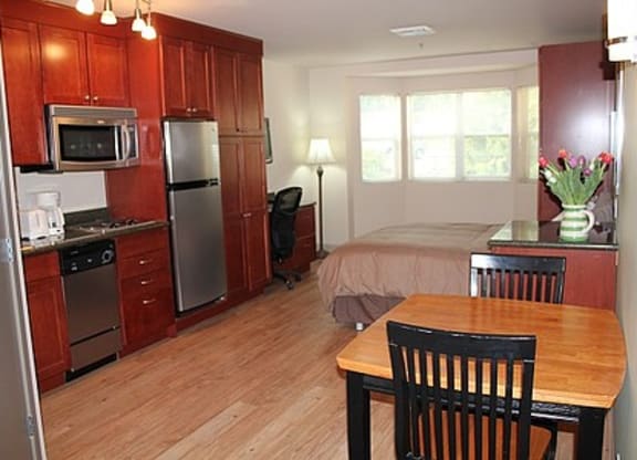 a kitchen with a table and a bed