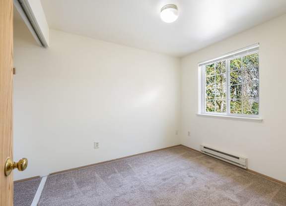 A room with a window and a door.