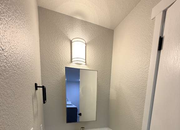 A bathroom with a sink and mirror.
