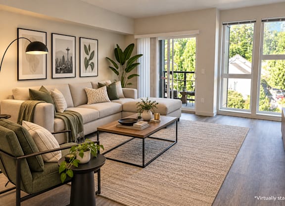 A living room with a couch, a coffee table, and a chair.