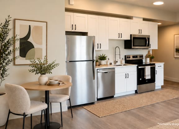 A modern kitchen with a table and chairs.