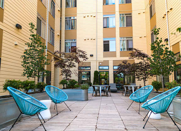Bode125's community courtyard with  seating, tables, and foliage