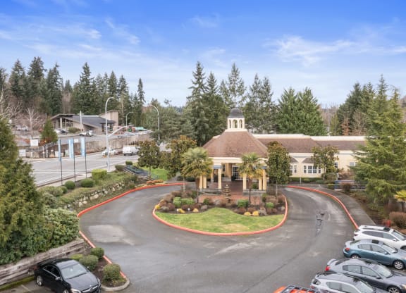 an aerial view of a building with cars parked in front of it