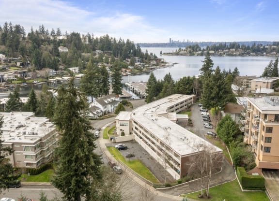 an aerial view of a building overlooking a city and a lake