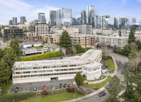 an aerial view of a building with a city in the background