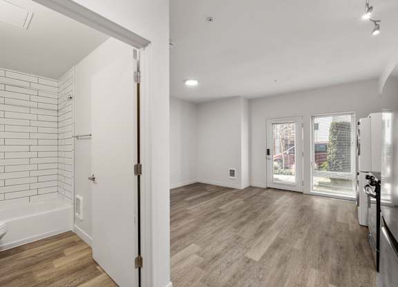 Studio apartment at Bode-88 with modern bathroom with white tile shower and luxury vinyl floor throughout