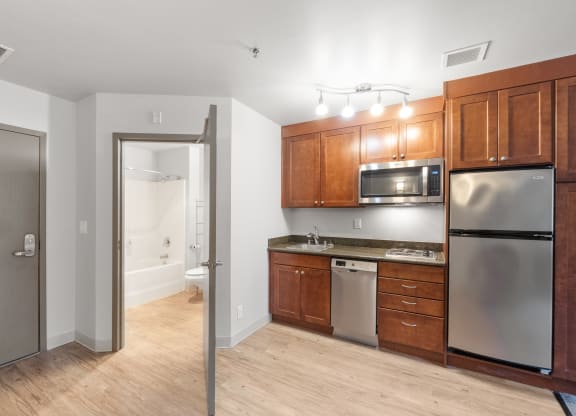 a kitchen with wooden cabinets and stainless steel appliances
