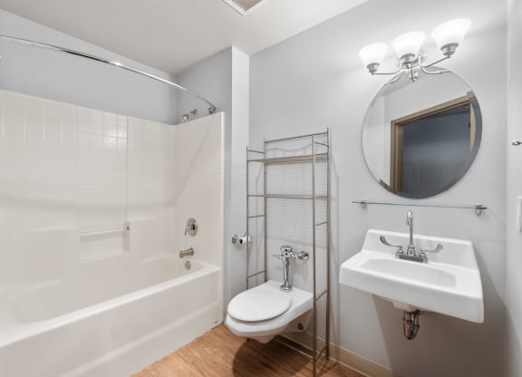 a bathroom with a shower sink and toilet and a mirror