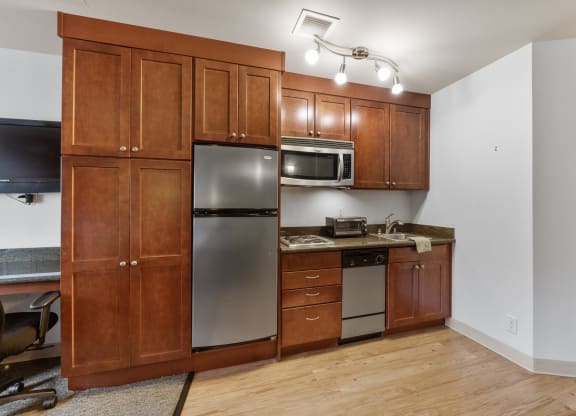 a kitchen with stainless steel appliances and wooden cabinets