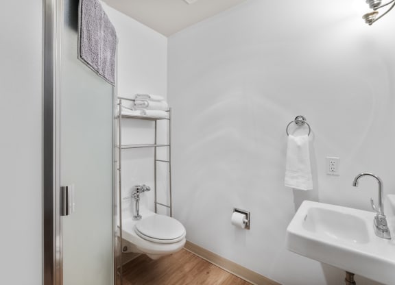 a bathroom with a toilet and a sink and a shower