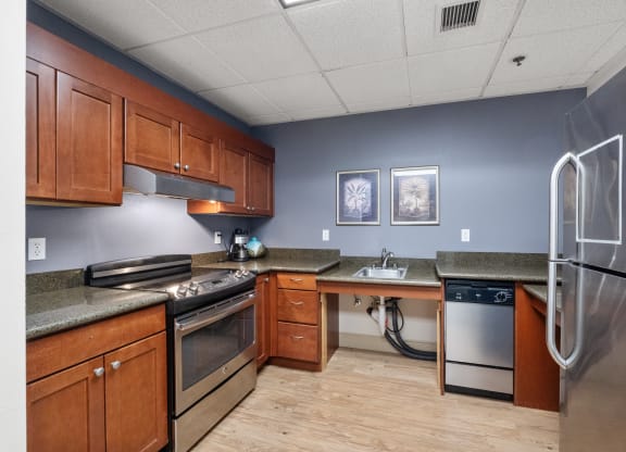 a kitchen with wooden cabinets and stainless steel appliances