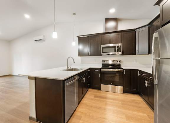 Modern kitchen with stainless steel appliances and hardwood floors