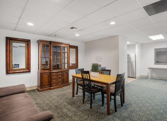 a conference room with a table and chairs and a couch