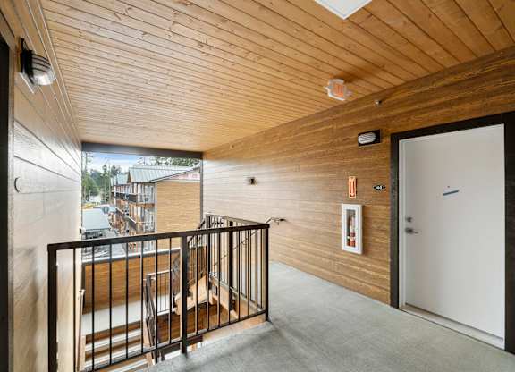 A balcony with a railing and a view of a building outside.