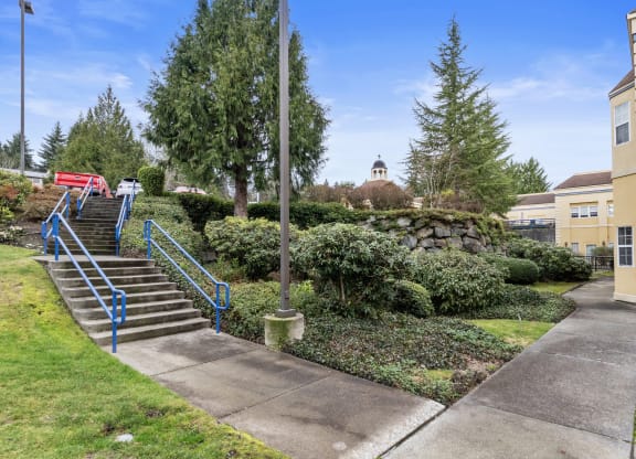 a staircase leading up to a building with stairs and a sidewalk