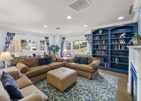 a living room with couches and a bookshelf