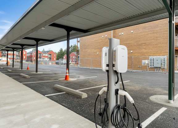 A parking lot with a charging station for electric vehicles.