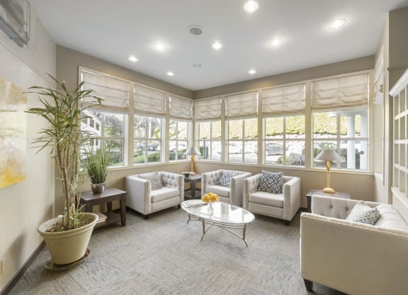 a living room with couches and chairs and a table