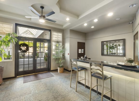 a kitchen with a bar and a door to a patio