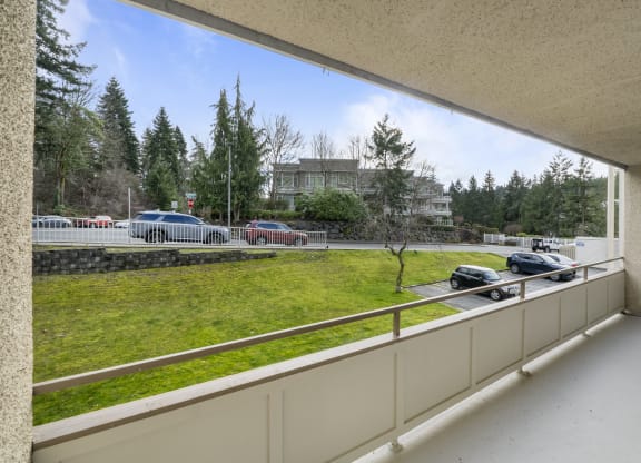 the view of a parking lot from a balcony of a building