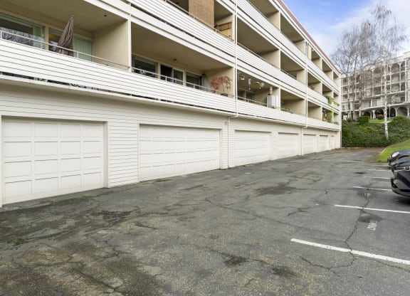 an empty parking lot in front of an apartment building