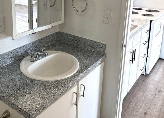 A bathroom with a sink and mirror.