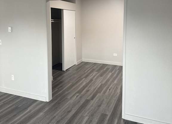 A room with a grey floor and white walls.