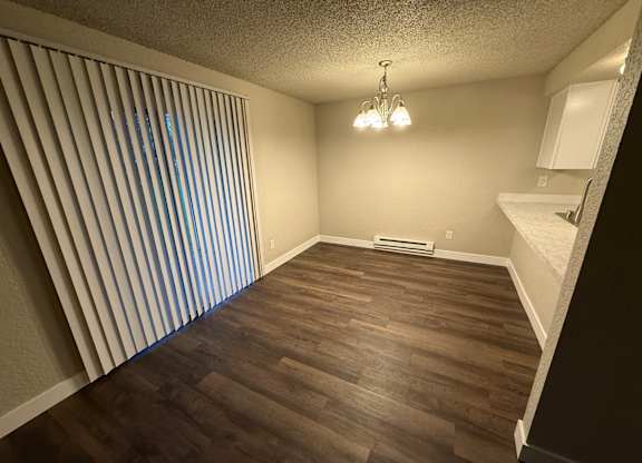 A room with wooden floors and a chandelier.