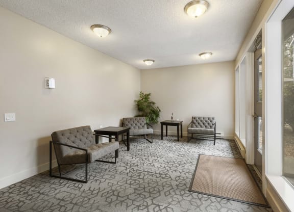 the preserve at cardinal woods resident lobby area with chairs and tables