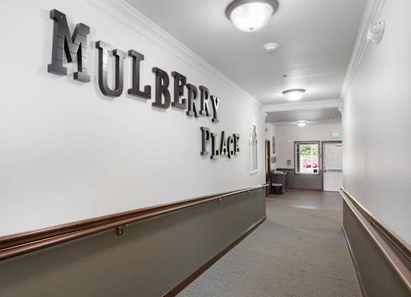 A hallway with the words "Mulberry Place" on the wall.