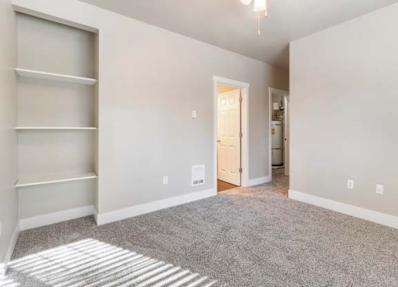 Primary bedroom with carpeting and a doorway leading to the bathroom