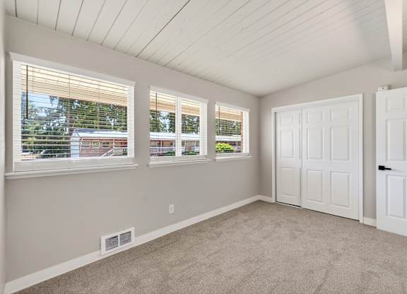 A room with white walls and a carpeted floor.