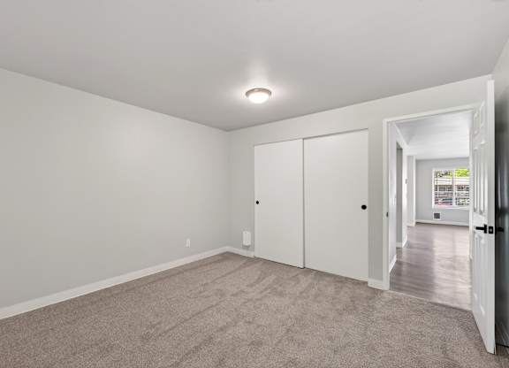 A room with a carpeted floor and white walls.