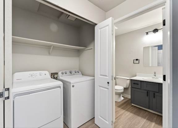 A small laundry room with a washer and dryer.