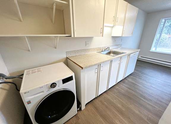 A small laundry room with a washer and dryer.