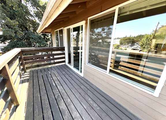 A wooden deck with a sliding glass door.