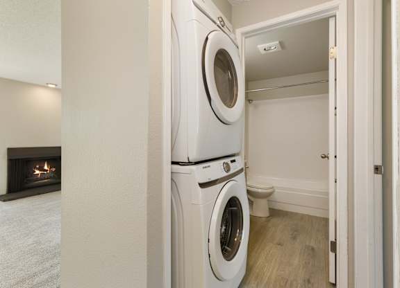 A washer and dryer near the bathroom in a 2-bedroom apartment at Hillcrest Estates