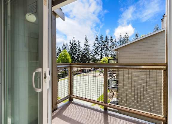 A view from a sliding doorway looking out to a balcony .