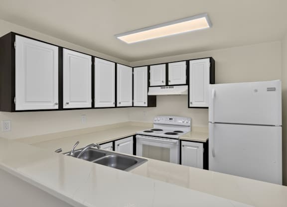 A kitchen with white appliances and cabinets.