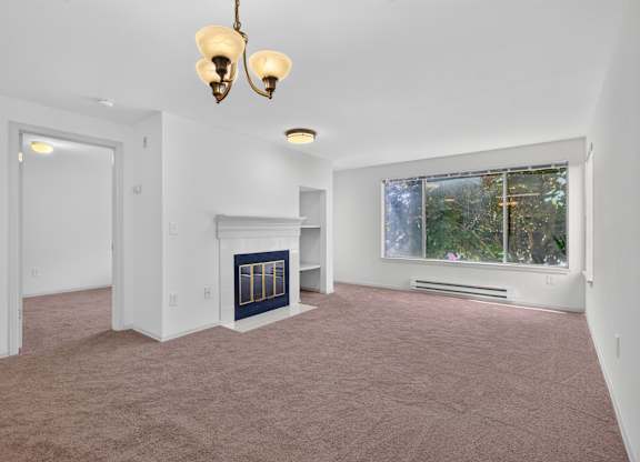 A room with a fireplace and a window.