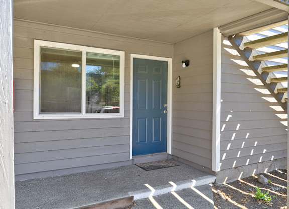 A house with a blue door and a window.