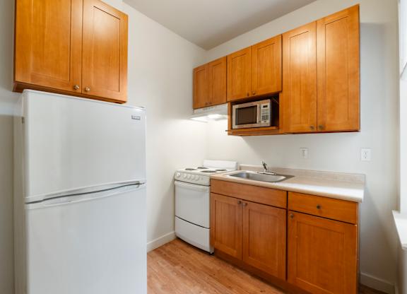 Studio kitchen with refrigerator, microwave, oven & range