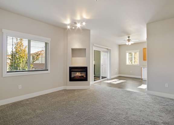 Hearthstone Apartments 2 bedroom apartment with carpeted living room featuring a fire place