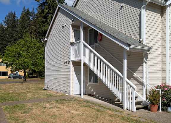 A house with a grey siding and white trim.